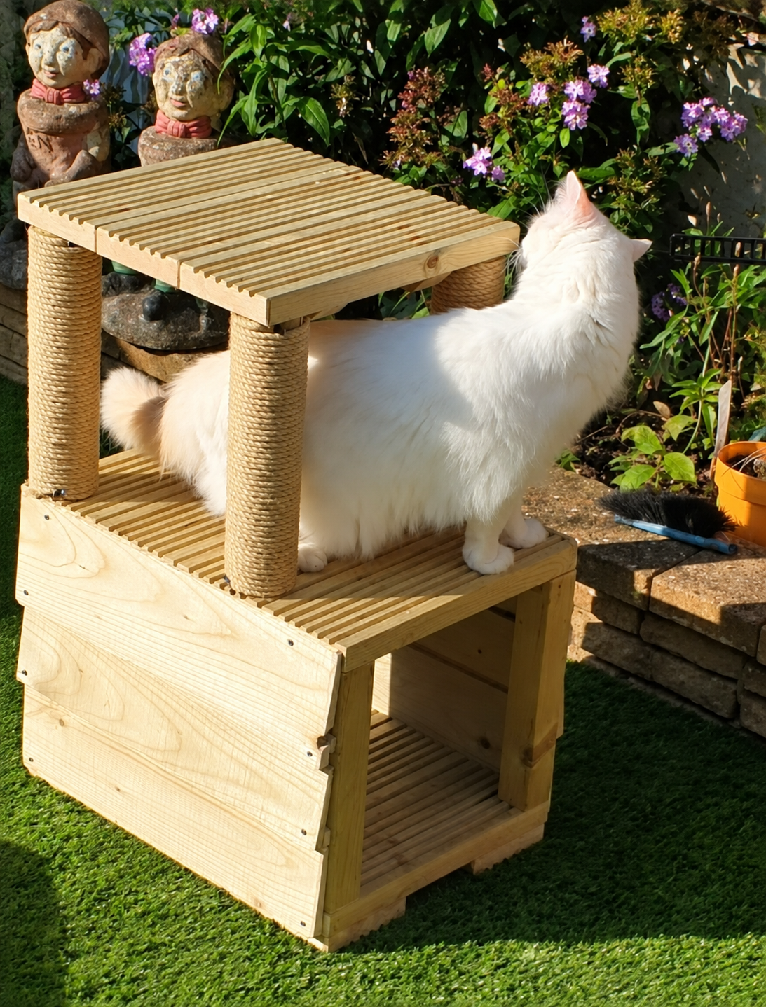 Wooden Play Tunnel outdoor cat tree with rope scratching posts and a white cat on the middle platform